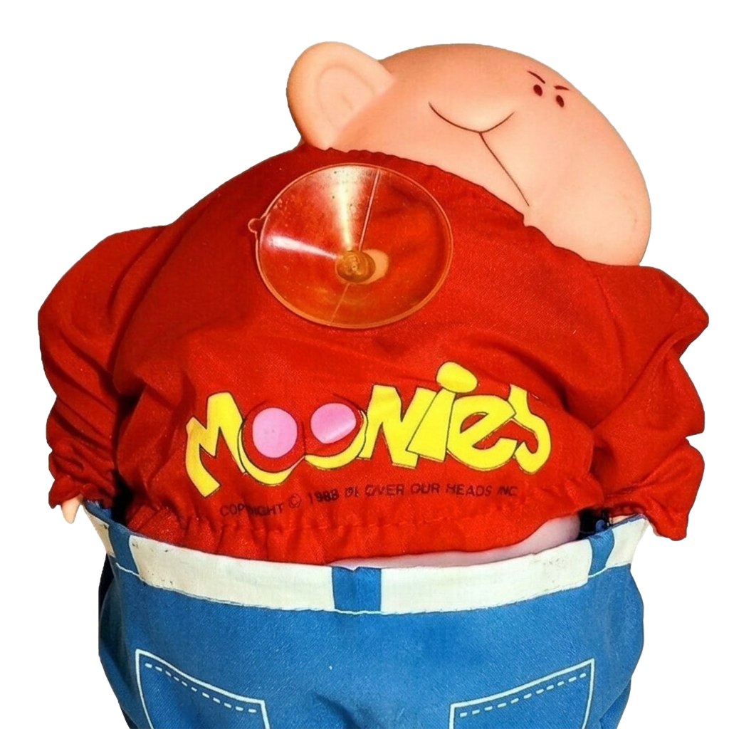 Moonies plush toy in red shirt and blue overalls
